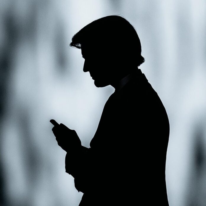 Silhouette Person Using Phone